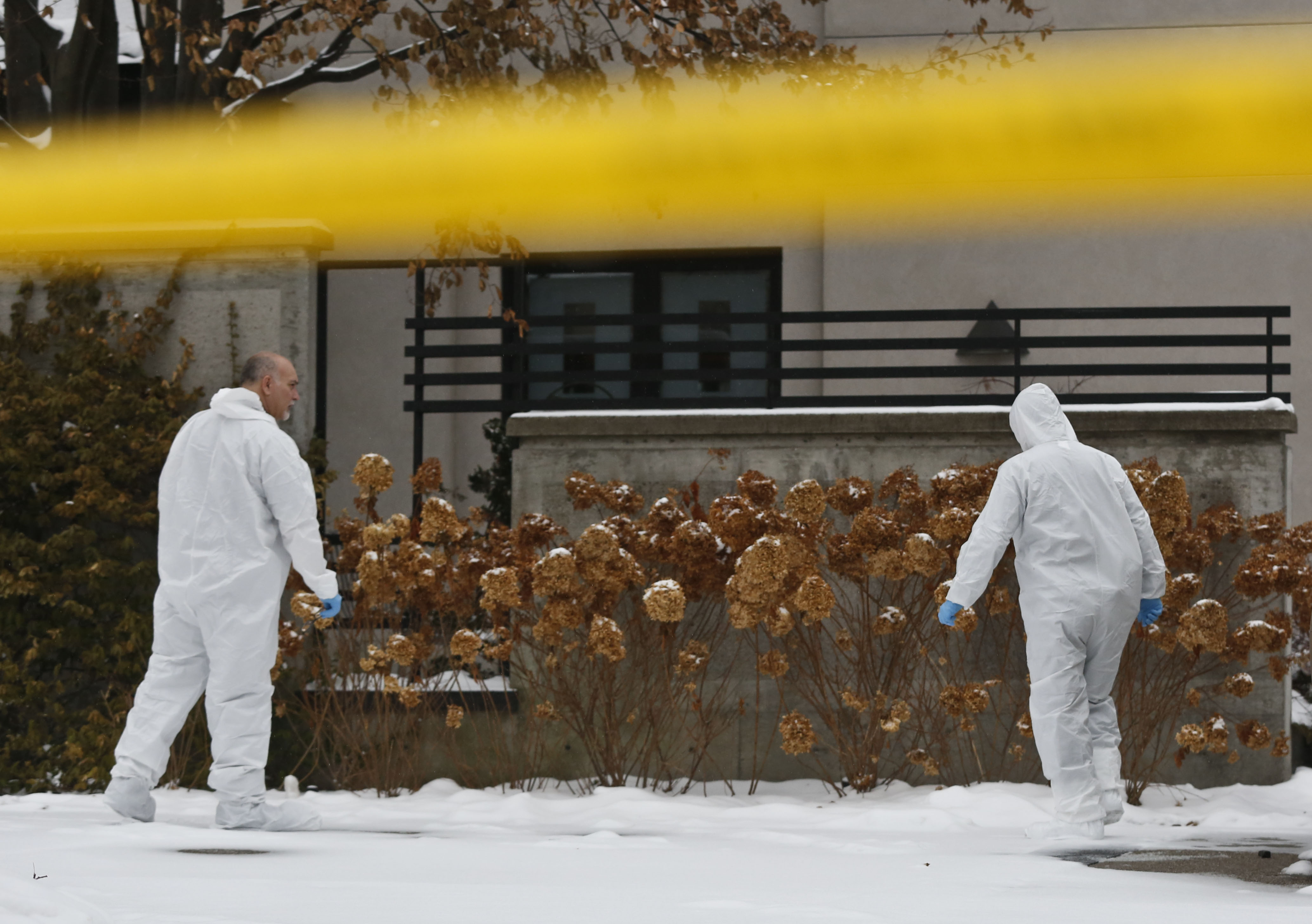 Forensic investigators gather evidence outside the home of Barry and Honey Sherman