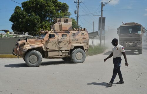 Armored police vehicles that are part of the Gang Suppression Force (GSF) patrol near the airport in Port-au-Prince